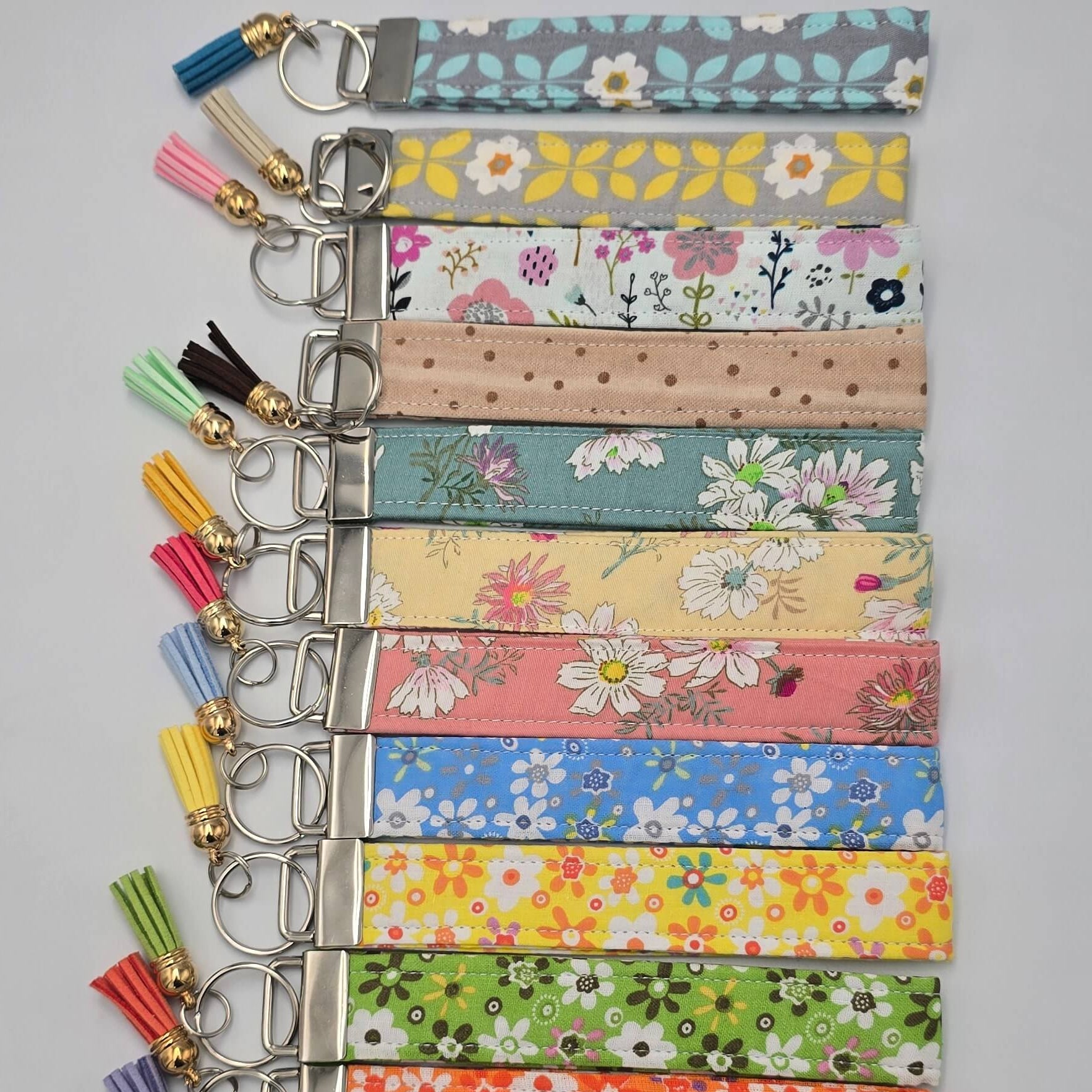 Set of colorful keychains with floral patterns on a gray background